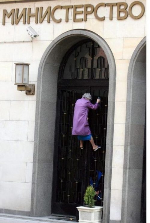 old lady climbing bank wall